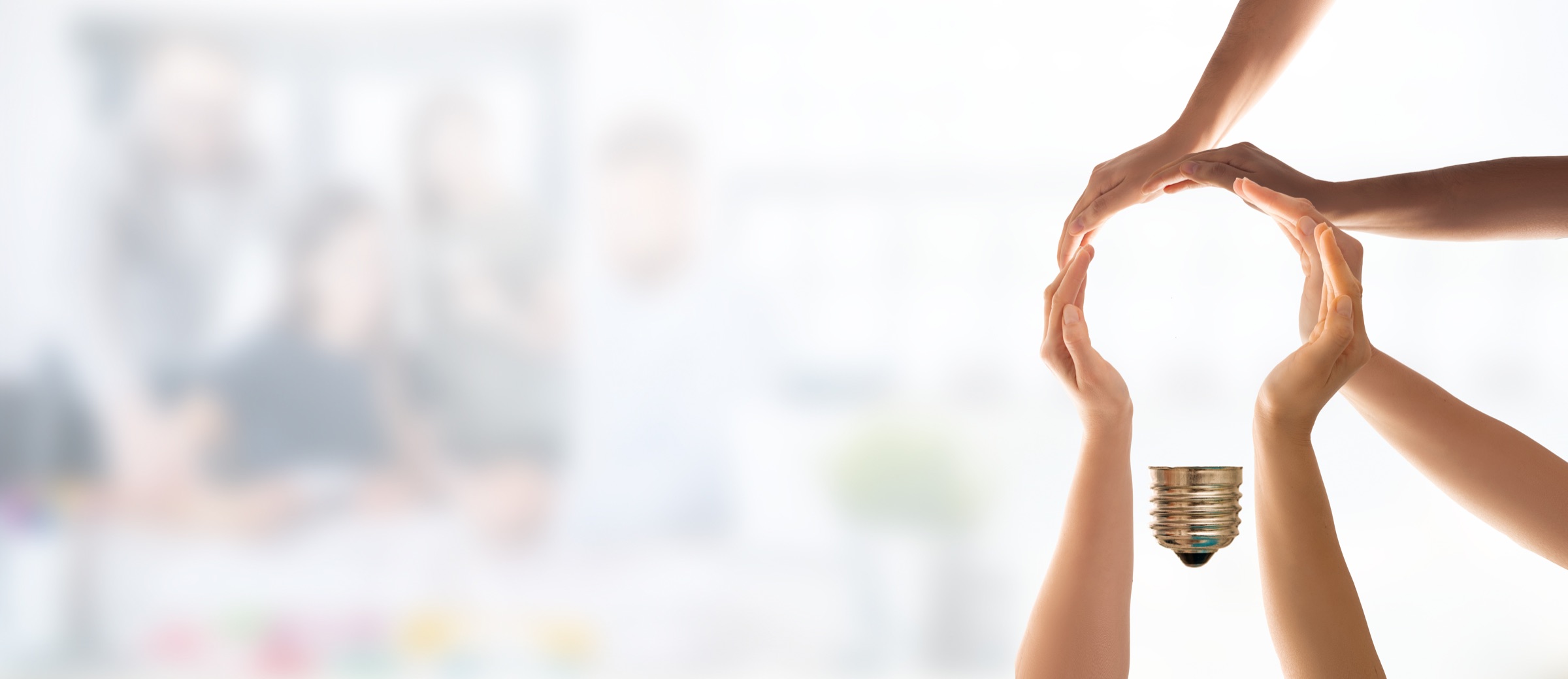 Hands forming the shape of a lightbulb.